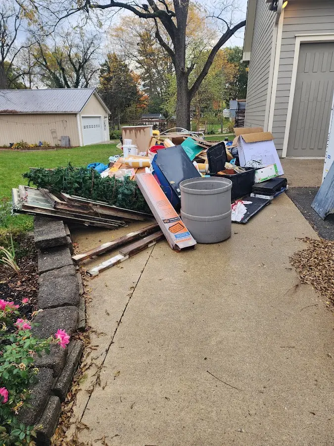 Dumpster being loaded with debris for Estate Cleanout Dumpster Rental in Fox Farm-College